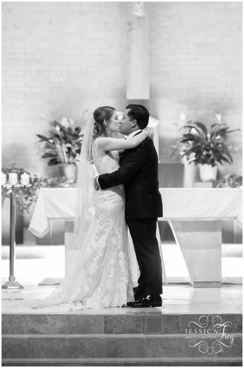 First Kiss as husband and wife at Saints Simon and Jude Catholic Church wedding 
