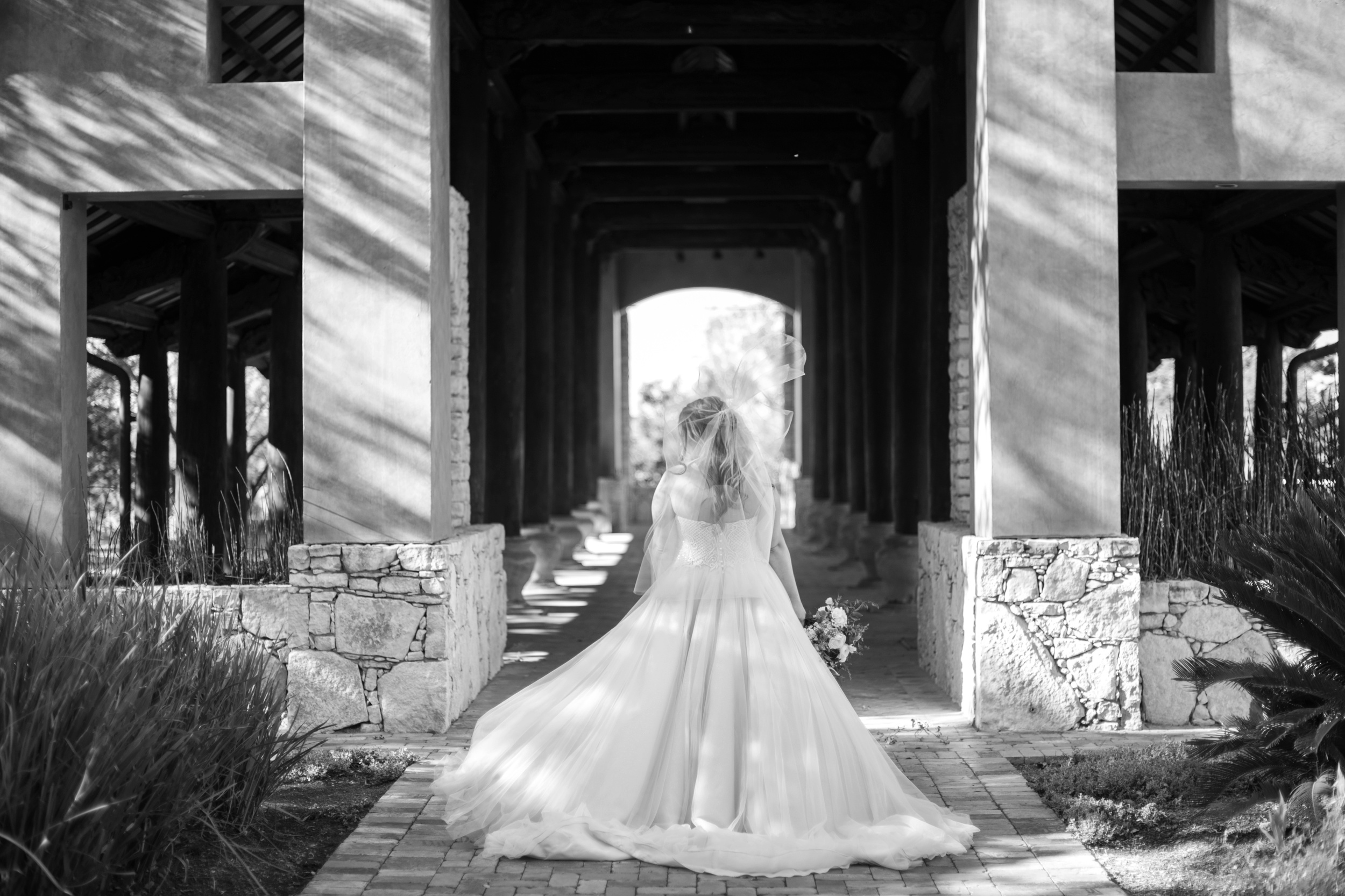 Bridal Portraits that showcase the back of the wedding dress at Camp Lucy's outdoor hall