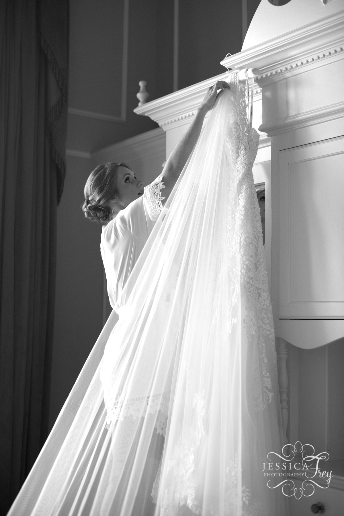 Bride reaches for wedding dress at the driskill hotel in Austin Texas