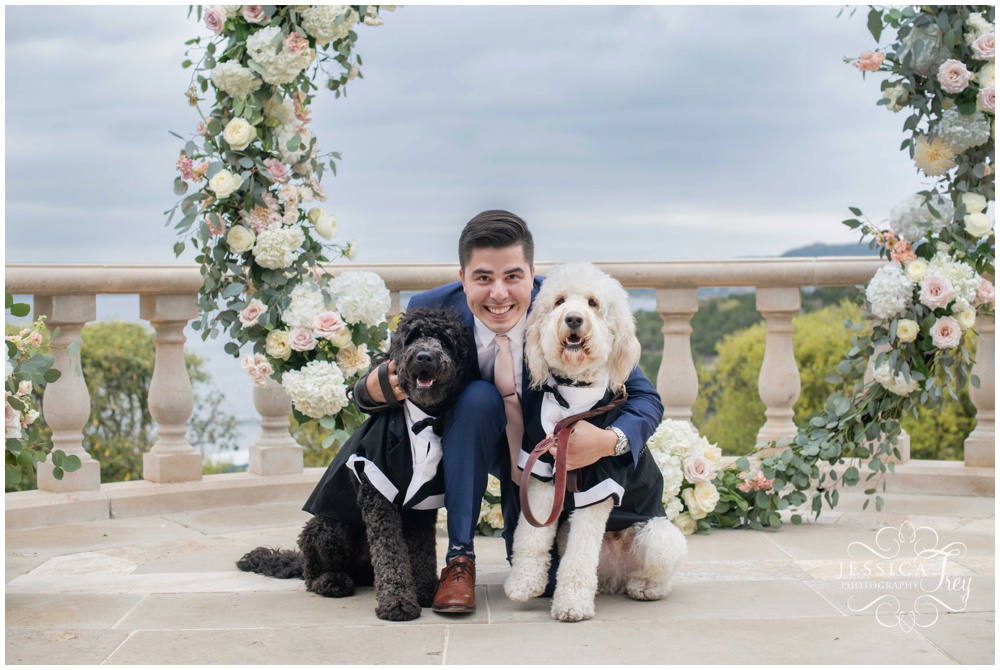 Grooms holds his furry friends just before his wedding ceremony at Villa Del Lago